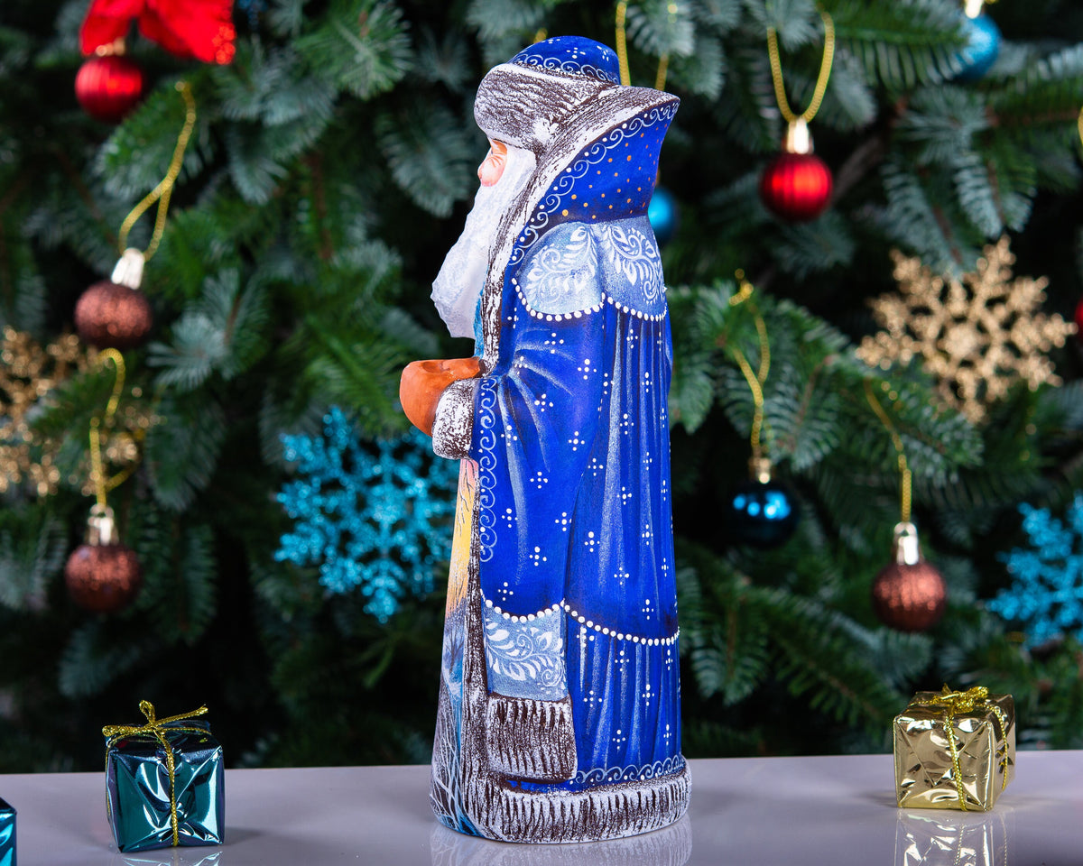 Hand carved wooden Santa figurine 9 inch, blue coat, winter landscape, holiday shelf decor