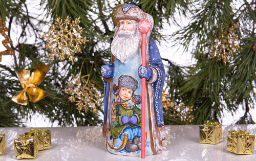 Hand carved and painted Santa 9 inch wooden figurine, snowy sledding scene, centerpiece