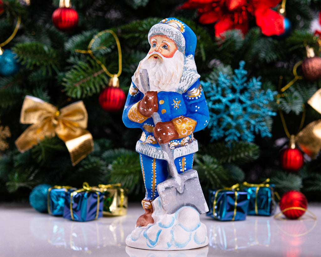 Father Christmas figurine with snow shovel in blue coat, 7.1 inch