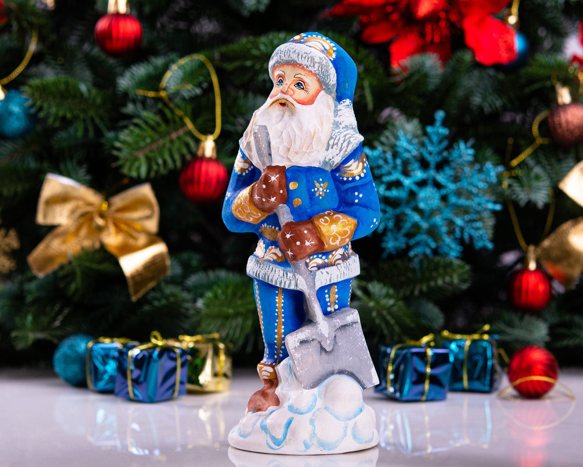 Father Christmas figurine with snow shovel in blue coat, 7.1 inch