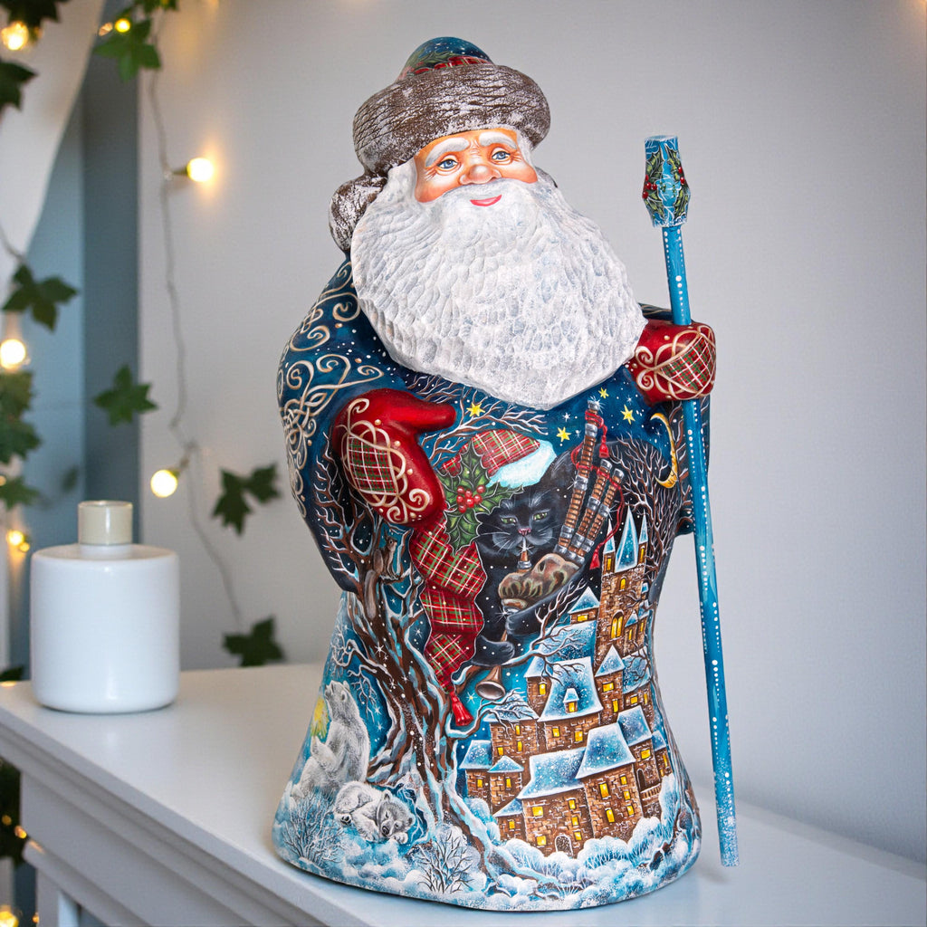 Decorative Santa Claus figurine with a winter scene design on a white surface.