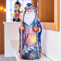 Hand carved wooden Santa figurine 9 inch, blue coat, winter landscape, holiday shelf decor