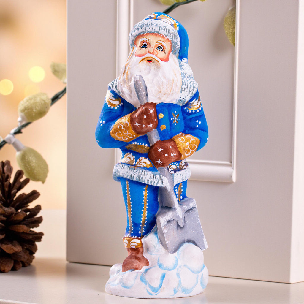 Father Christmas figurine with snow shovel in blue coat, 7.1 inch