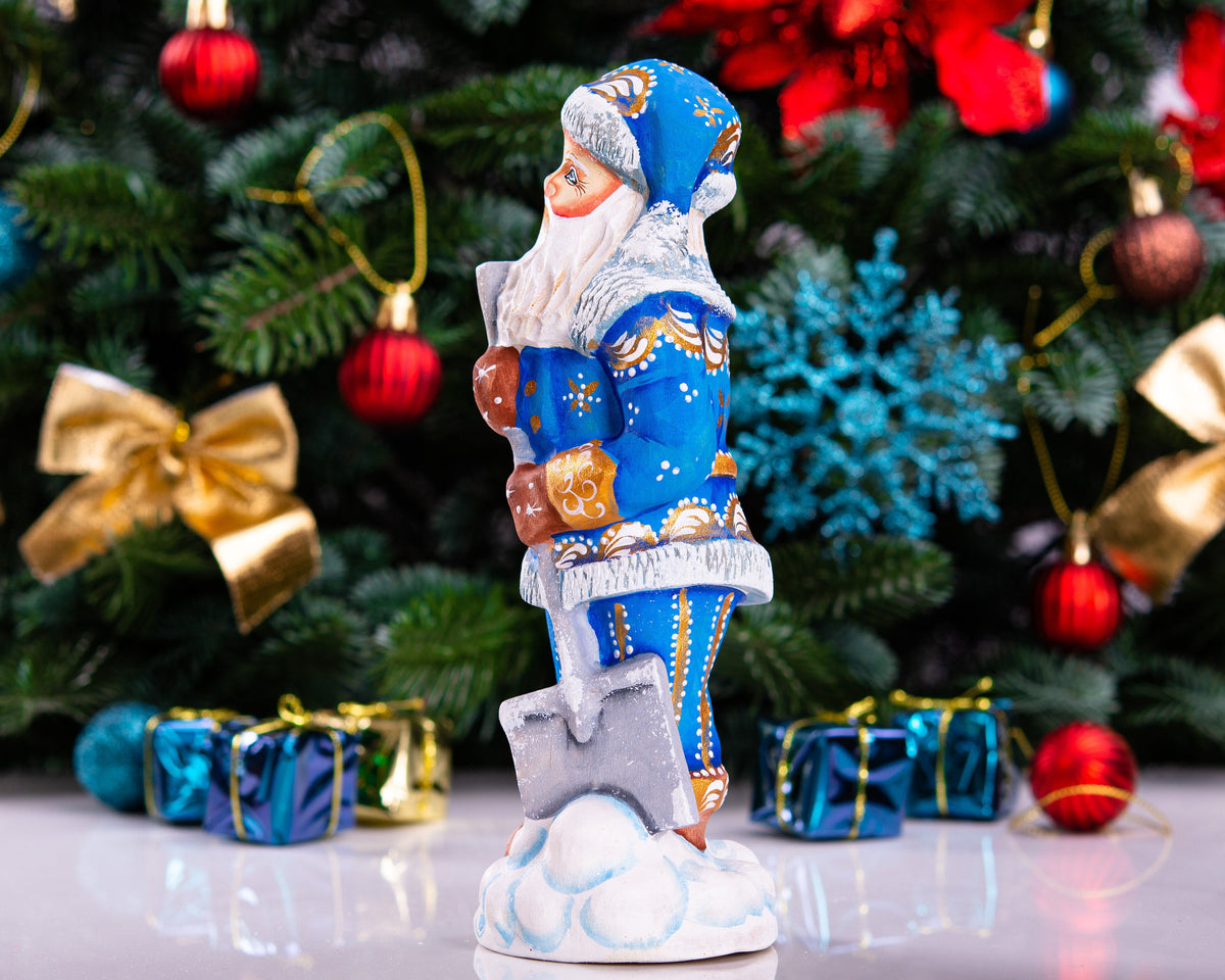 Father Christmas figurine with snow shovel in blue coat, 7.1 inch