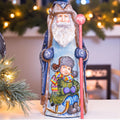 Hand carved and painted Santa 9 inch wooden figurine, snowy sledding scene, centerpiece