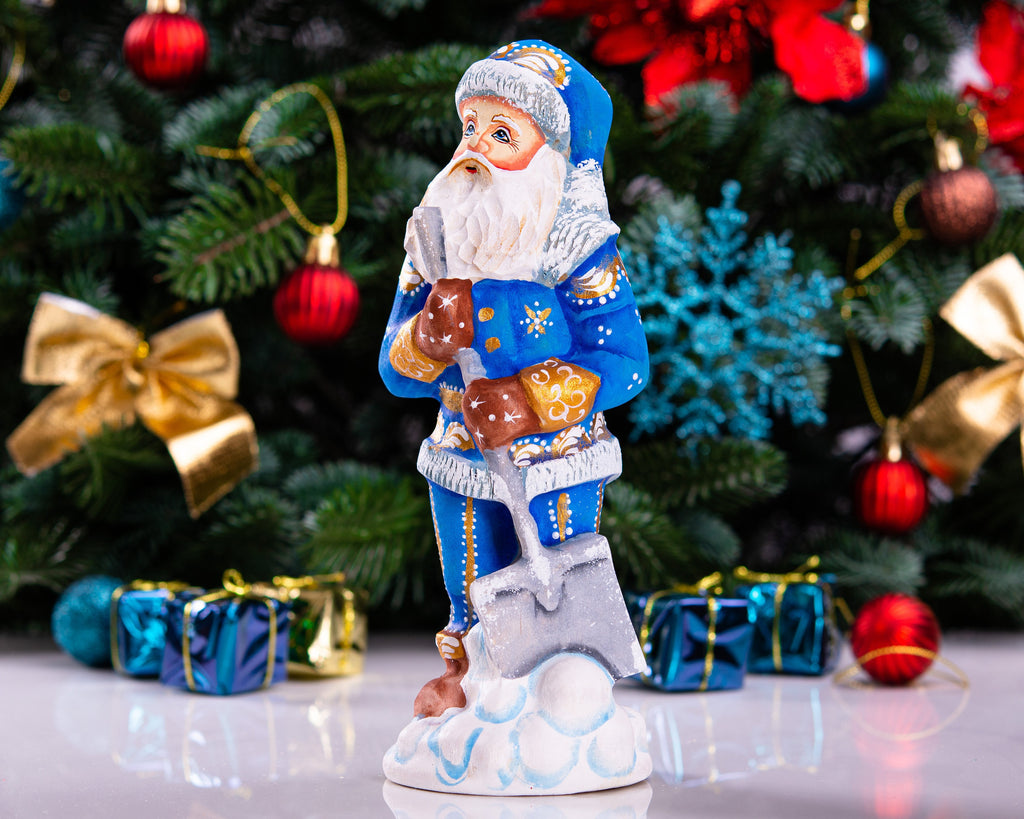 Father Christmas figurine with snow shovel in blue coat, 7.1 inch
