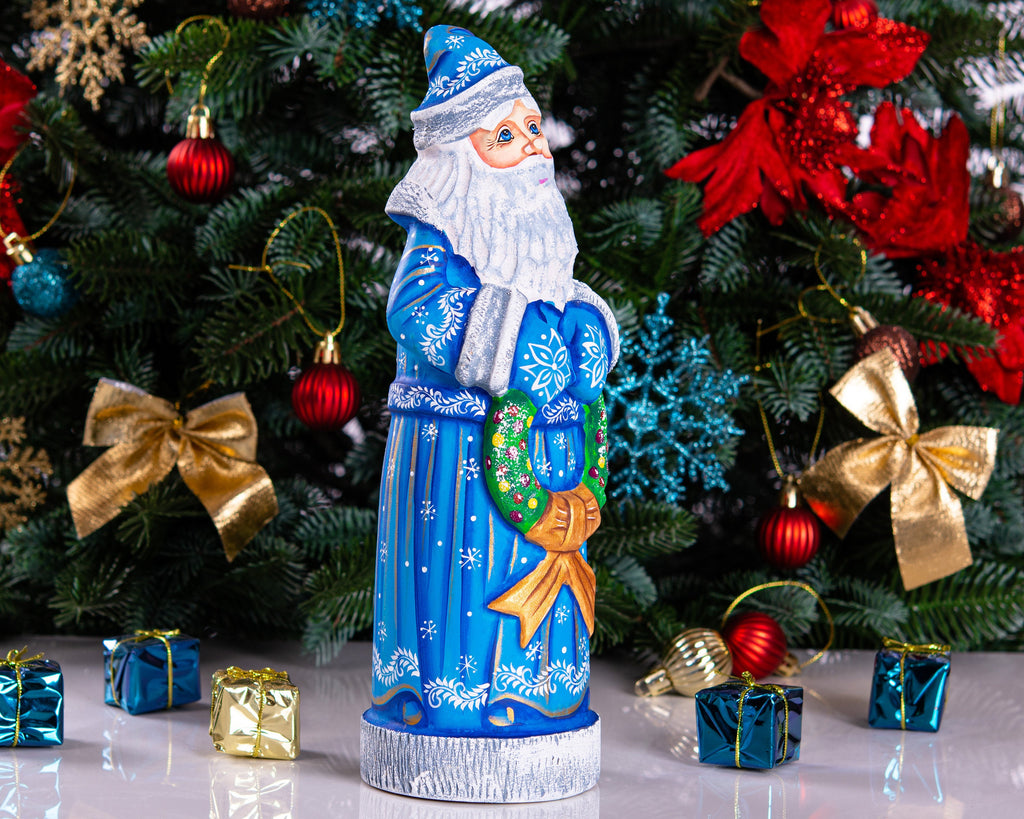 Blue Santa wood carving 11.5 inch, holding wreath, Christmas shelf or mantel decor